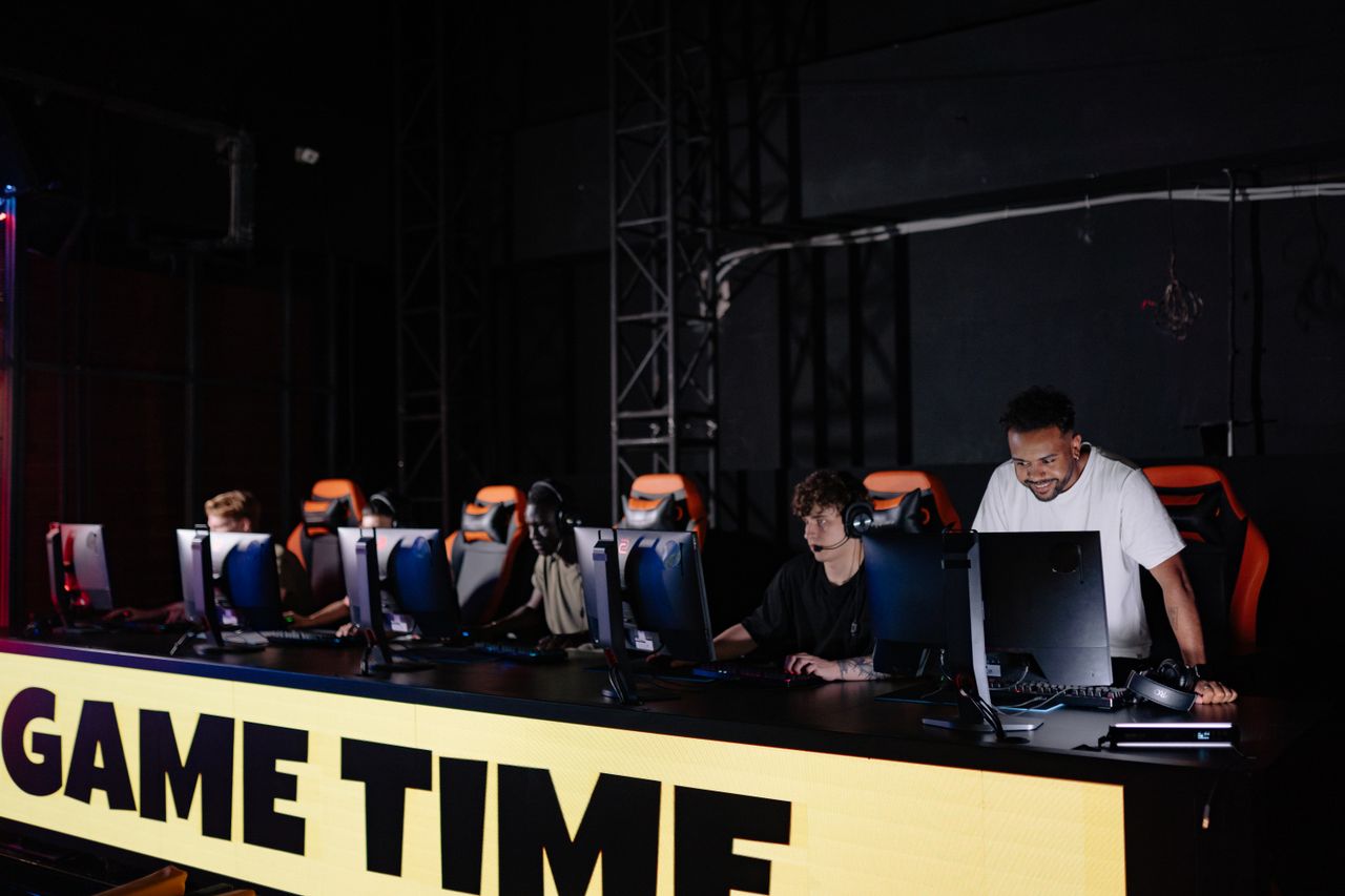 Crafting Captivating Headlines: Your awesome post title goes here Esports team engaged in competitive gaming session indoors, showcasing teamwork and concentration.